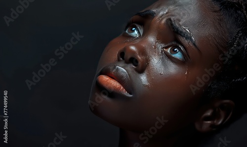 Violence and abuse of girls theme: portrait of a beautiful young girl with tears in her eyes, a sad woman in the studio