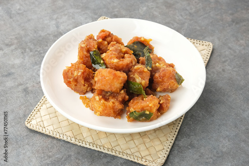 Salted egg fried shrimp or udang telur asin with curry leaves
