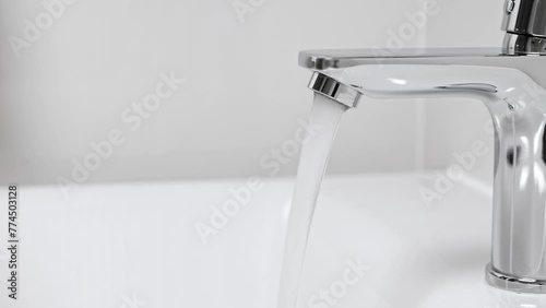 Water running from faucet closeup. Nobody