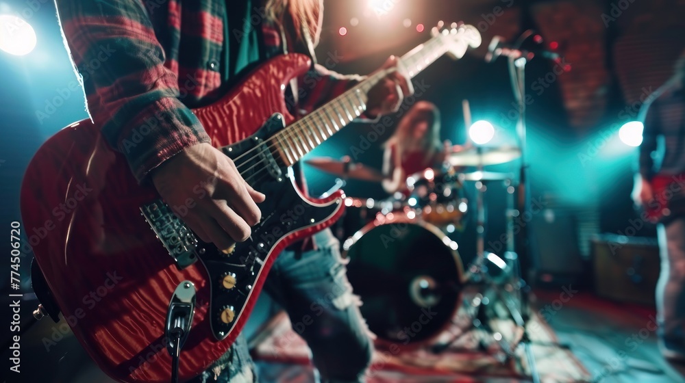 Obraz premium Close up on electric guitar, Music band perform on stage, electric guitar, bass guitar and drums,