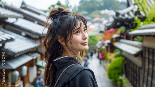 Young Woman Enjoying Scenic Tourist Area with Traditional Architecture on Overcast Day