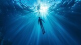 man swimming under the sea rising to the surface with rays of the sun entering in high resolution and quality. concept swim,sea
