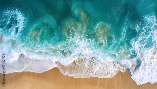 Aerial view showcases a sandy beach near the sea, waves gently lapping the shore