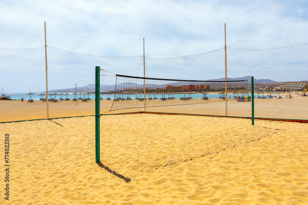 Volleyball net on the sandy beach. Playa del Castillo in Fuerteventura, Canary Island Volleyball net on the sandy beach. Playa del Castillo in Fuerteventura, Canary Island