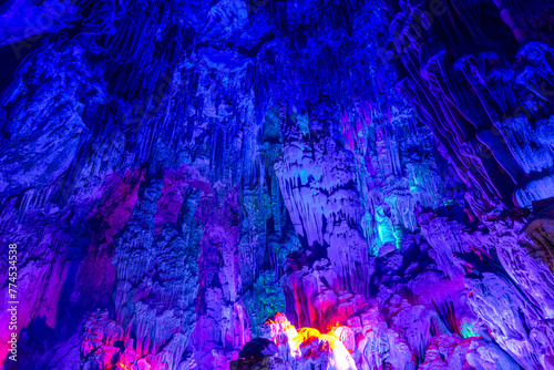 Fototapeta Naklejka Na Ścianę i Meble -  beautiful illuminated multicolored stalactites from karst Reed Flute cave