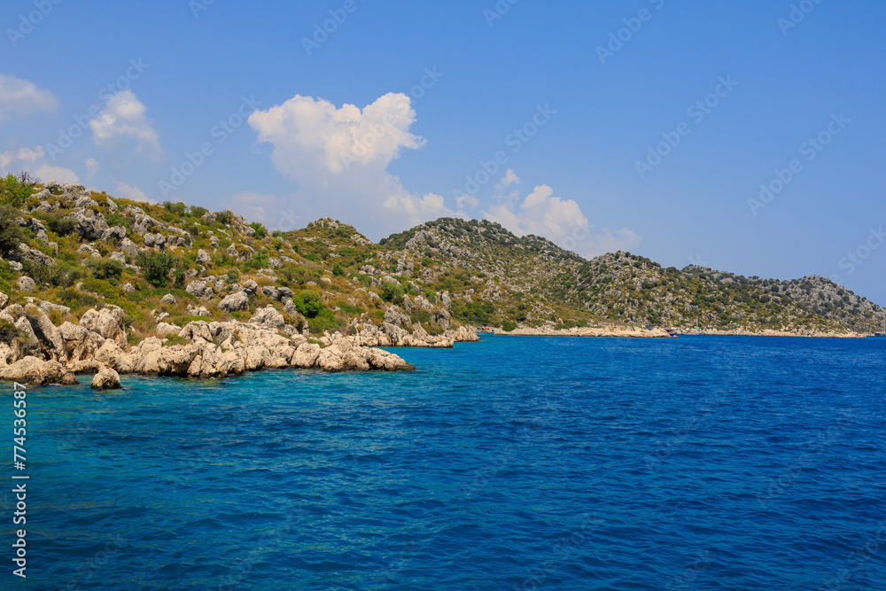 View of the rocky shore from the sea. Mediterranean Sea in Turkey. Popular tourist places. Background