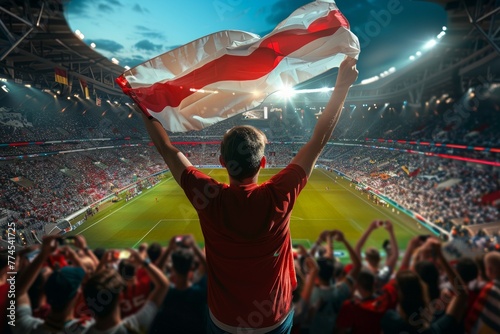 A man is holding a flag in a stadium full of people. Football fan supporting the team