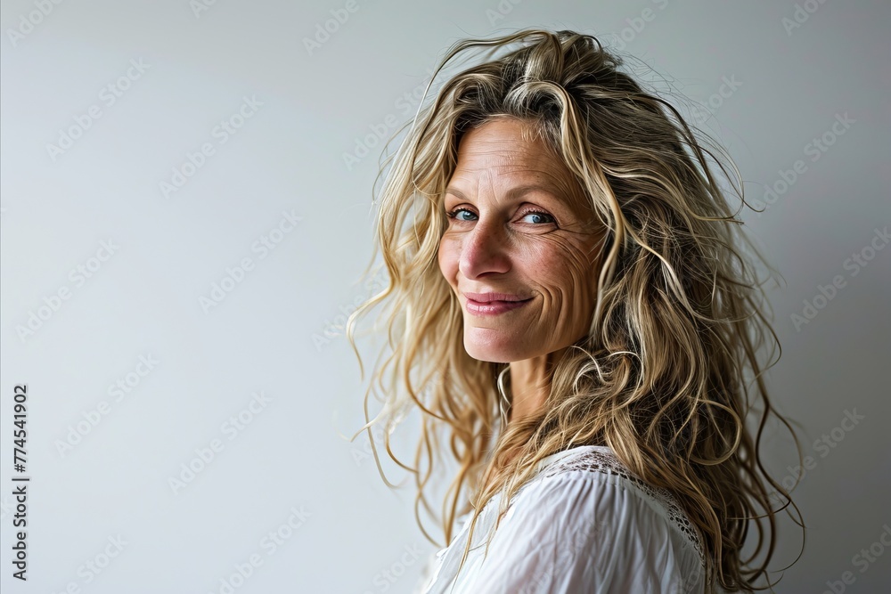 Portrait of a beautiful middle aged woman with long blond hair in studio Portrait of a beautiful middle aged woman with long blond hair in studio