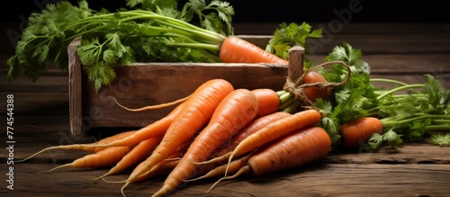 Fresh orange carrots arranged in a group on a rustic wooden table in a close-up shot