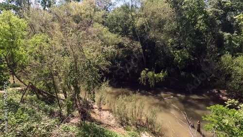 The San Antonio River flowing through the city of Floresville, Texas in Wilson County.  (ID: 774547776)