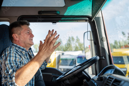 Nervous truck driver arguing with somebody in traffic, closeup shot, cursing 