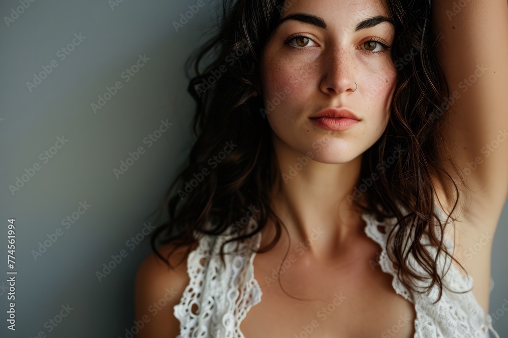 Portrait of a beautiful young woman with long curly hair and makeup