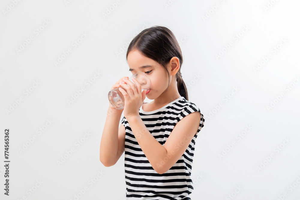 asian girl Standing and Smiling little with a holding an empty glass of water asian girl Standing and Smiling little with a holding an empty glass of water