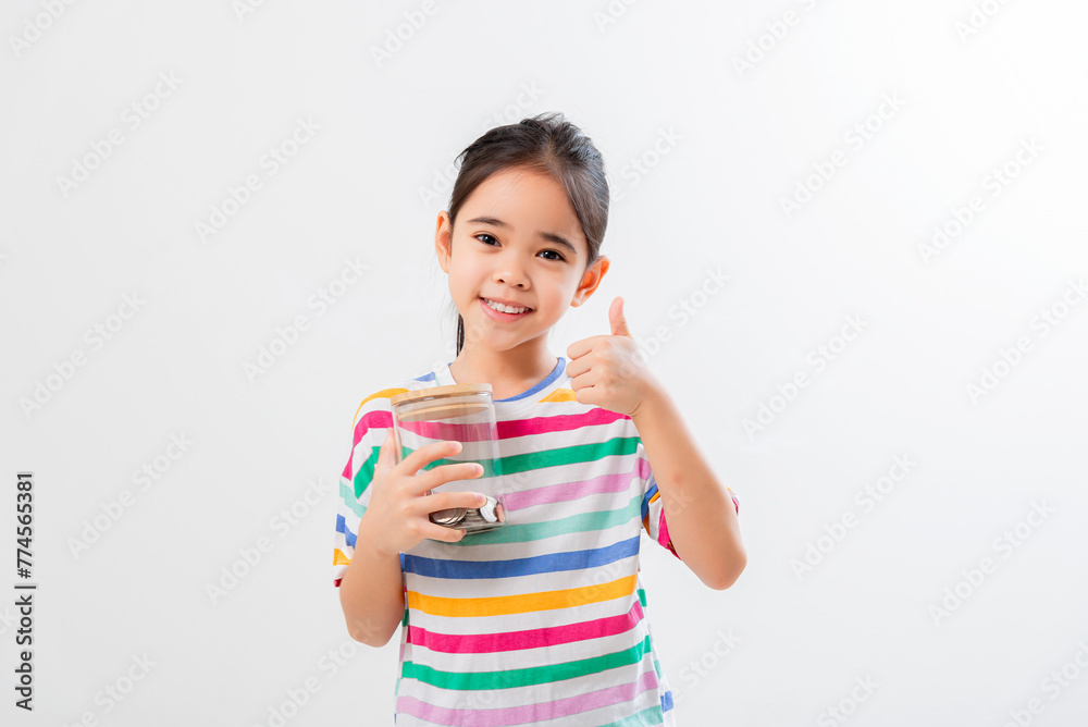 Little Asian girl saving money in a piggy bank, learning about saving, Little Asian girl saving money in a piggy bank, learning about saving,