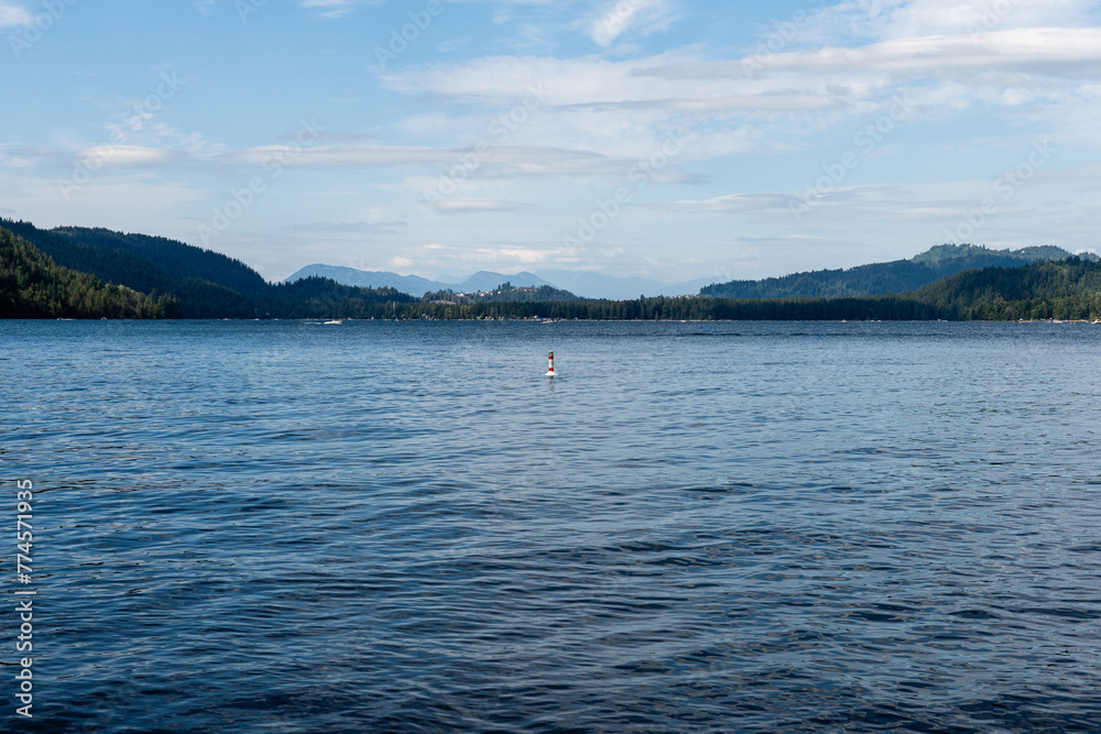 day time on mountain lake with calm water and cloudy sky