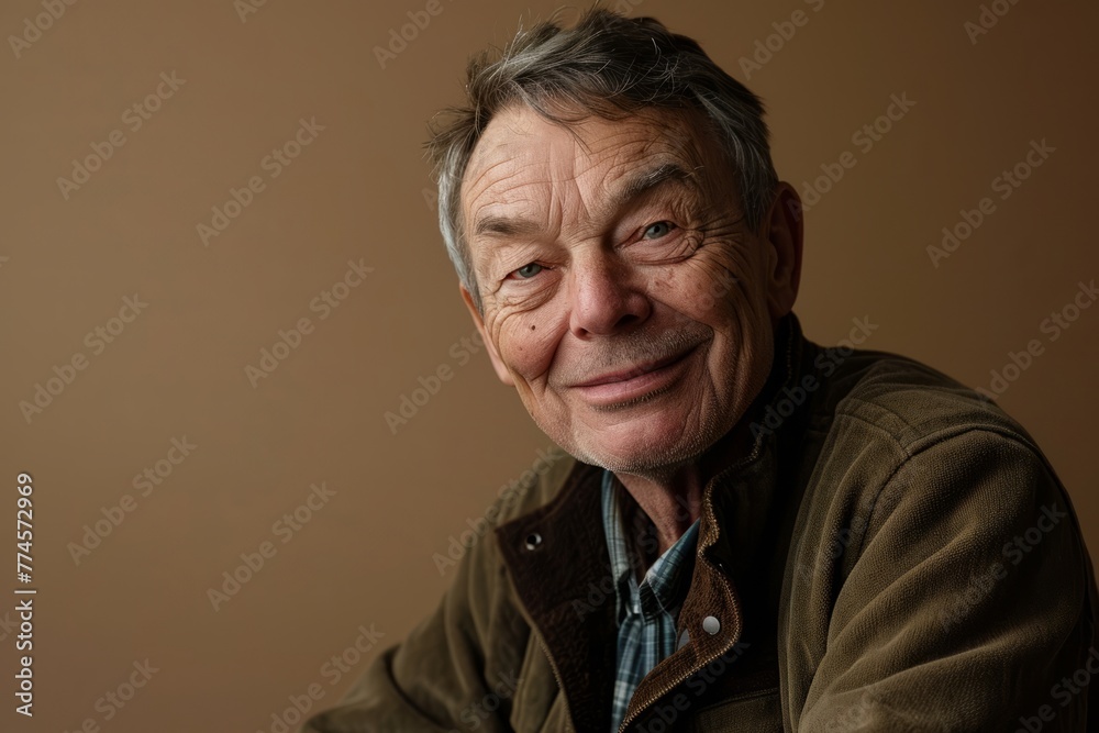 Portrait of an elderly man on a brown background. Close-up. Portrait of an elderly man on a brown background. Close-up.