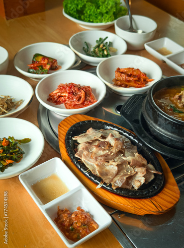 Korean grilled sliced meat with side dishes. High angle view.