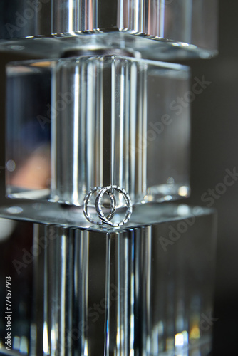 A close-up of wedding rings on a reflective surface photo