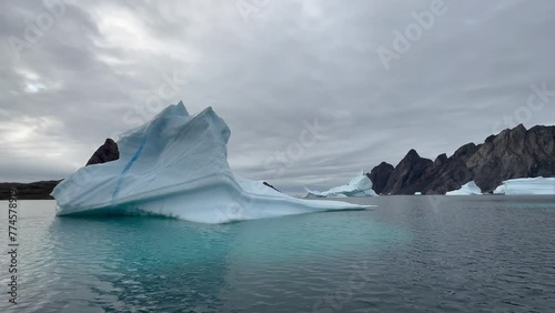 Pan right view of icebergs at Bear Islands. Scoresbysund, Greenland. photo