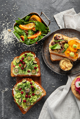 Vegan toast with avocado mushroom and fresh salad on dark background. Vegetarian food concept