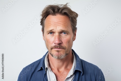 Portrait of a handsome mature man looking at camera with serious expression