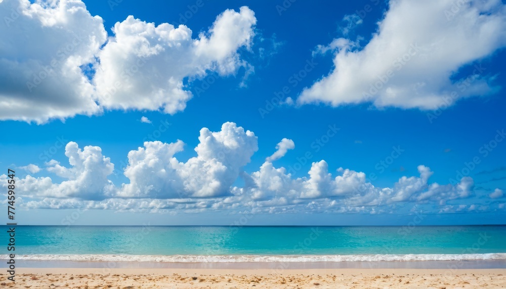 A beach with a blue sky and white clouds