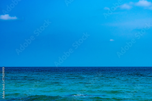 Ocean sea background and the clear sky For summer vacation ideas Nature of summer sea water with sunlight The sea sparkles against the blue sky.  
