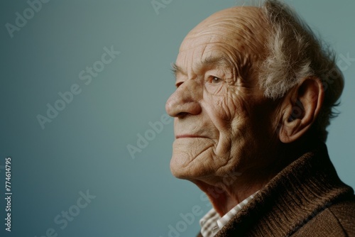 Portrait of an elderly man on a blue background. Toned.