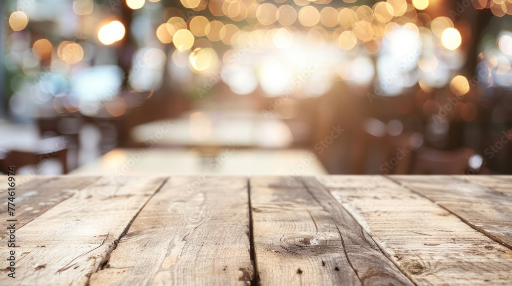 A wooden table under a soft glow of blurry lights in the background A wooden table under a soft glow of blurry lights in the background