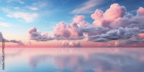 A large body of water reflecting the blue sky, enveloped by fluffy pink clouds photo