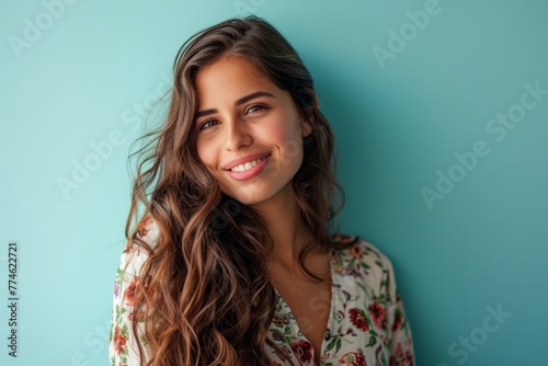 Portrait of a beautiful young woman with long wavy hair.