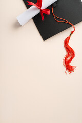 Celebrate success with a flat lay vertical top view composition showcasing mortarboard, and rolled diploma against a pastel background, offering space for your greeting text or marketing message