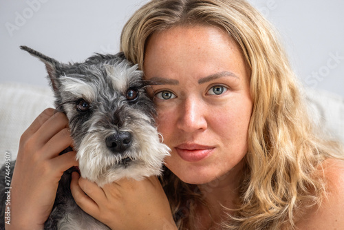 Portrait of a girl with a miniature schnauzer dog