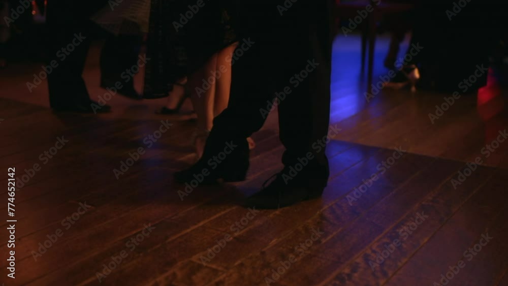 foot steps in the floor of a milonga dancing Argentine Tango in a moody bar cafe