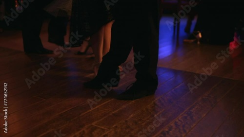 foot steps in the floor of a milonga dancing Argentine Tango in a moody bar cafe