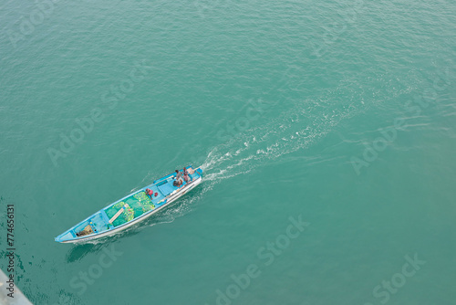 Close up of a splashing boat on the ocean. Aerial view from Pamban bridge, Rameswaram