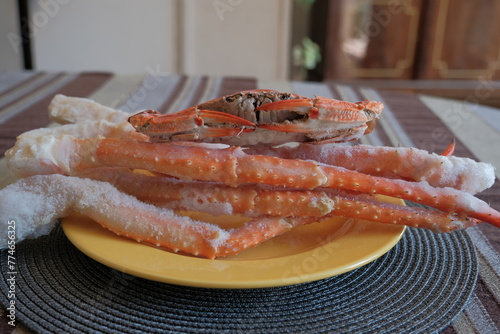 boiled frozen crab. red and white crab claws. king crab legs on a plate