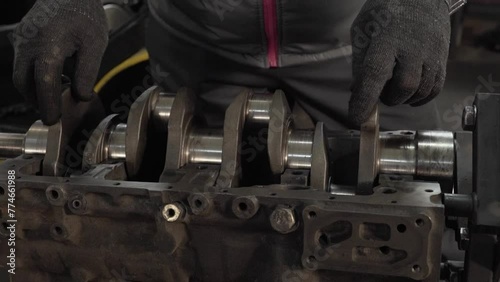 master inserts crankshaft into engine
