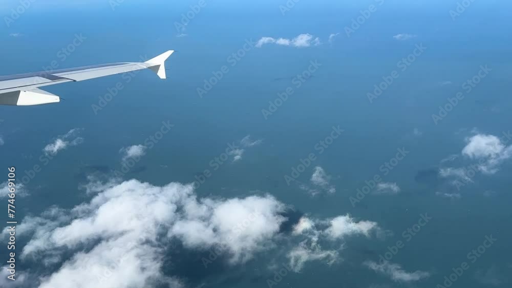 Aerial view from a plane: Ocean, clouds, and wing captured in a captivating journey through the skies. Aerial view from a plane: Ocean, clouds, and wing captured in a captivating journey through the skies.