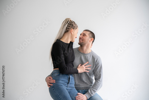 Joyful Couple Sharing a Laugh and fun Together at home against white wall
