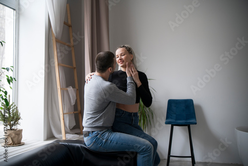 Romantic Couple in casual clothes Sharing an Intimate tender Embrace Inside a Cozy Room