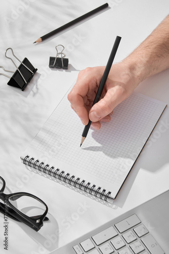 Person Writing on Notebook With Pen