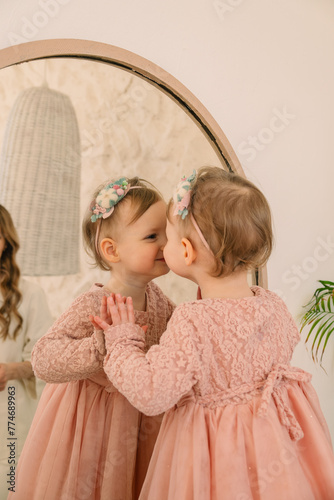 cute smiling toddler girl near mirror