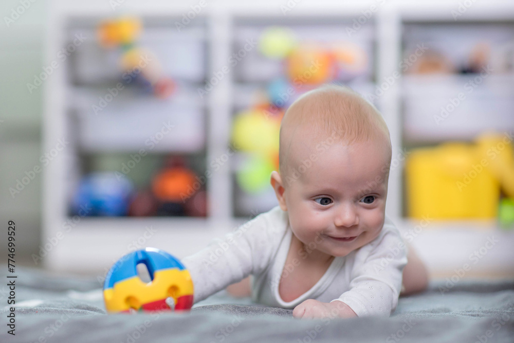 Baby reaching for toy. Baby development Baby reaching for toy. Baby development