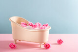 Bath full of water with soap foam with roses on pink and blue background. Minimal spa card.