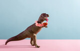 Cute dinosaur drinks coconut water and wears necklace of flowers on pink and blue background.
