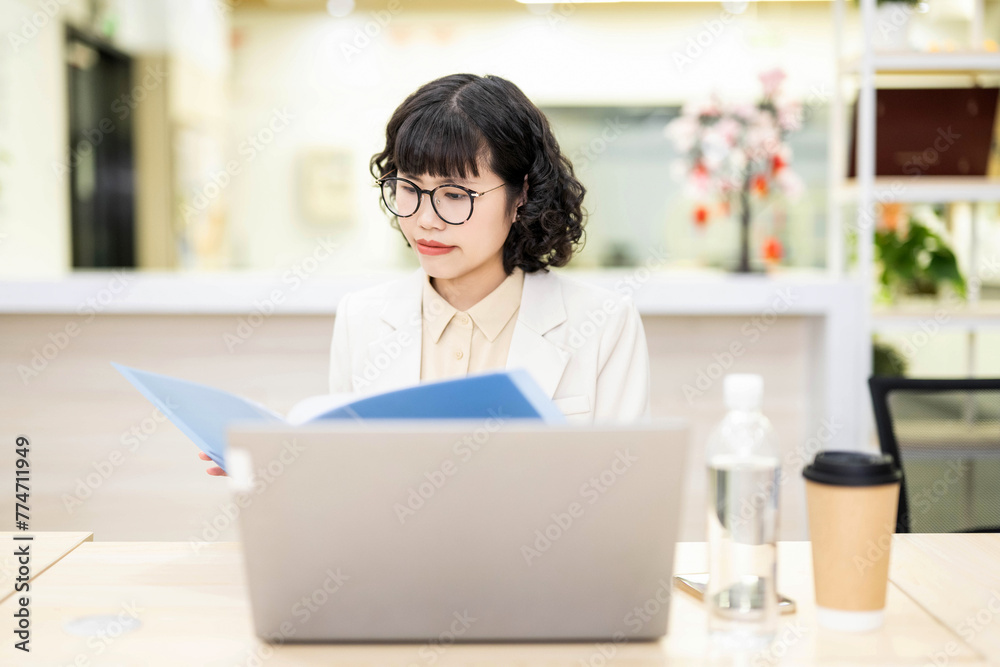 White-collar worker reading documents in office White-collar worker reading documents in office