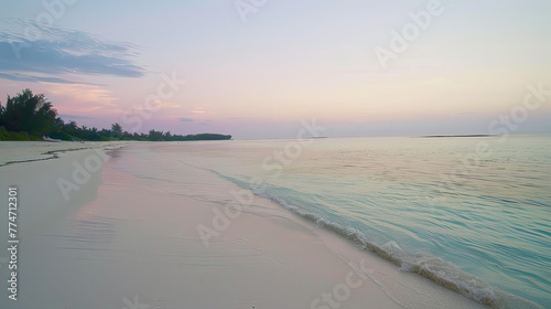Beach shoreline at pastel sunrise clear ocean white sand soft waves