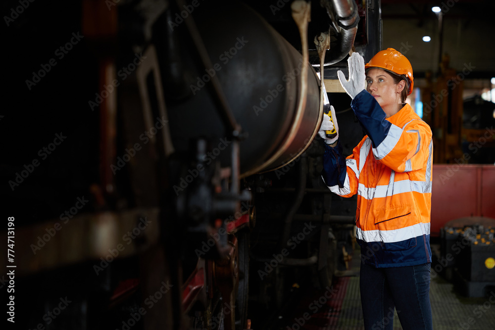 engineer or technician checking construction train at station