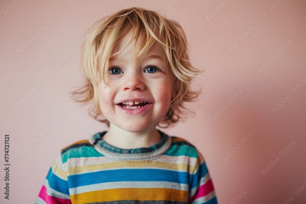 Portrait of a smiling little boy with blond hair on a pink background Portrait of a smiling little boy with blond hair on a pink background